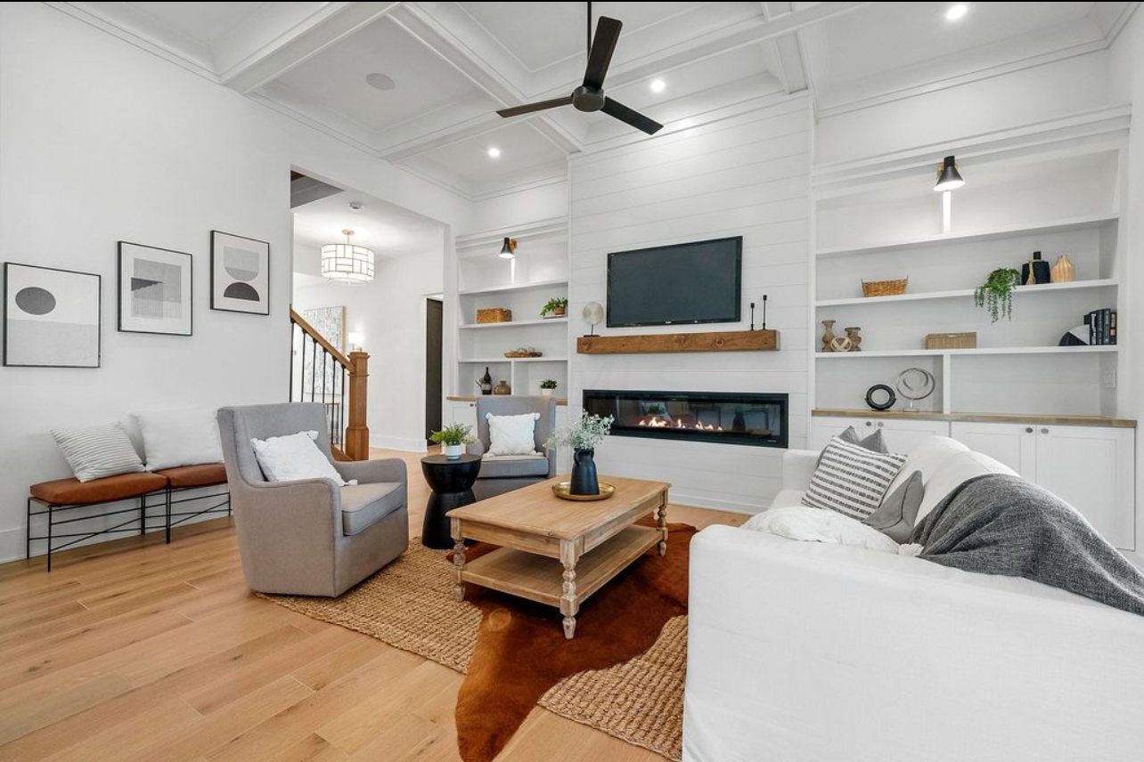 Great room fireplace by Three A Homes