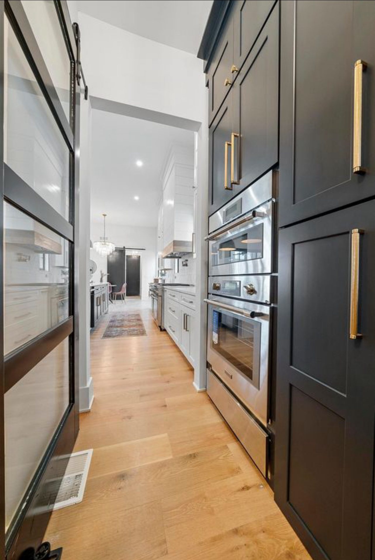 Walk-through pantry by Three A Homes